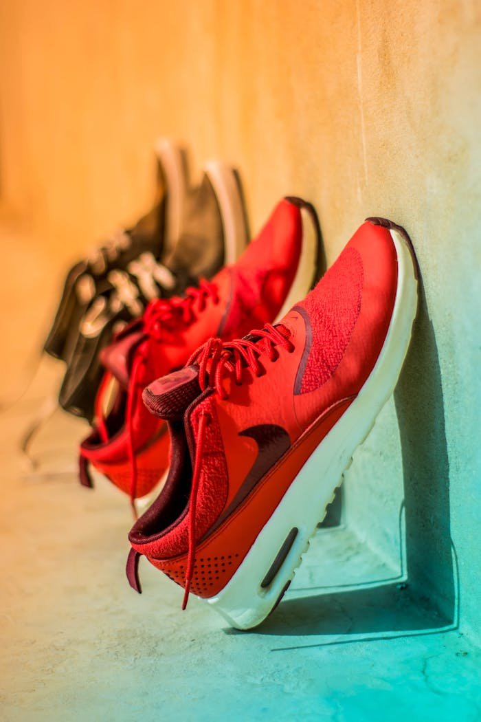 Vibrant red sneakers on display, showcasing modern footwear style.